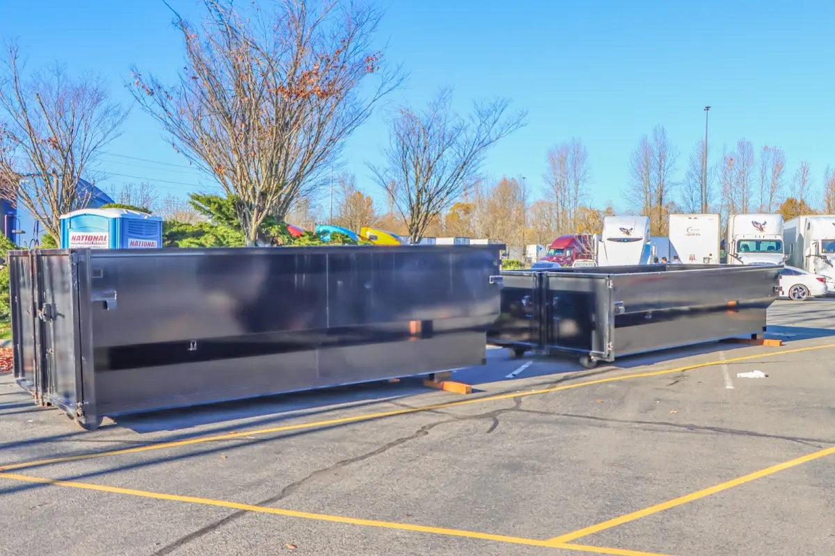 Professional dumpster rental service with roll-off container on residential driveway in Eau Claire